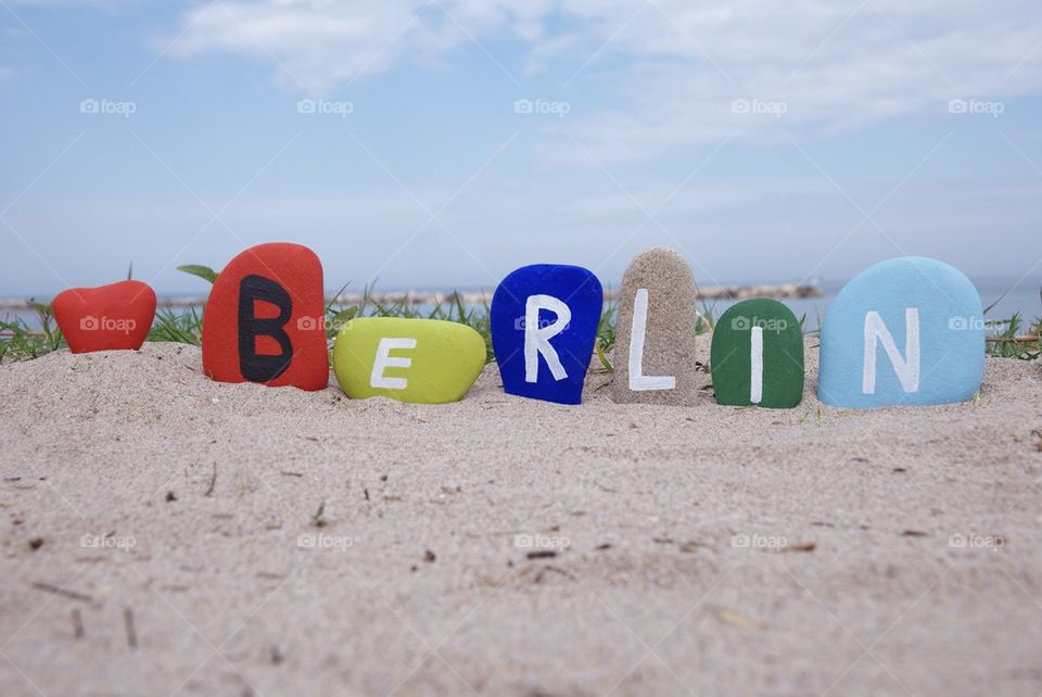 Souvenir of Berlin on colourful stones on the sand