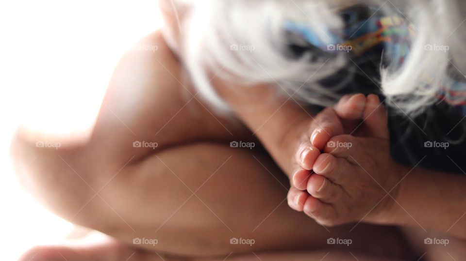 Front view of fingers hand in meditative prayer position white haired