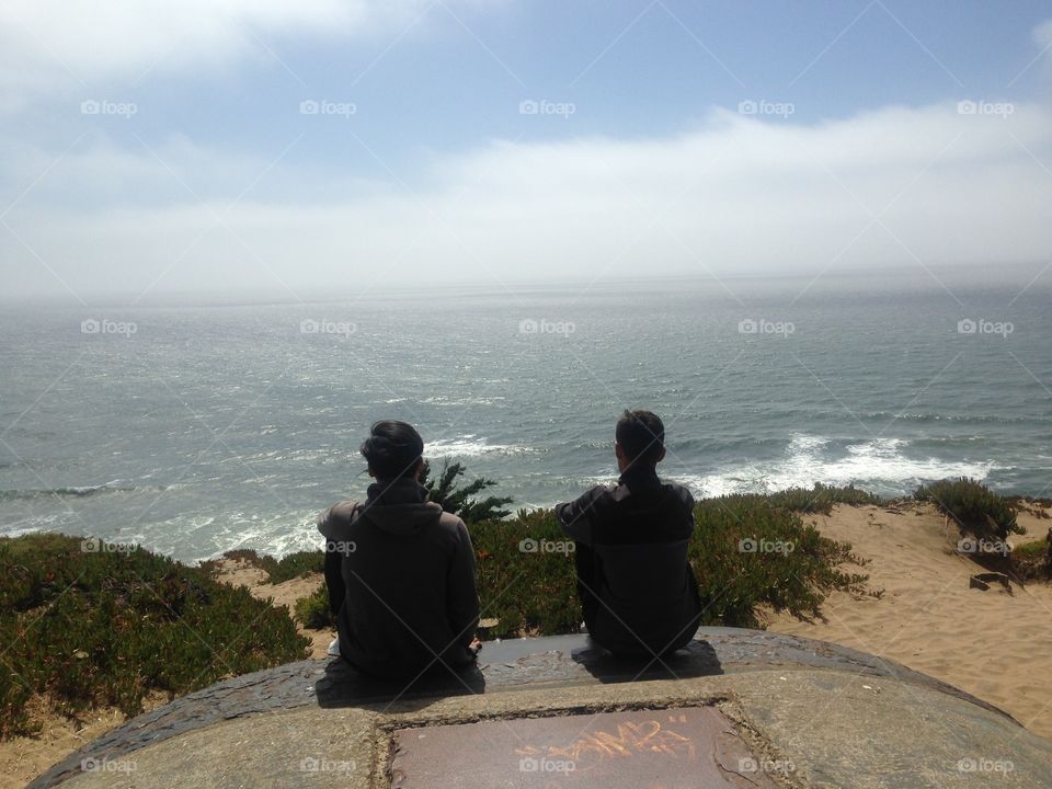 Two brothers enjoying the ocean view 