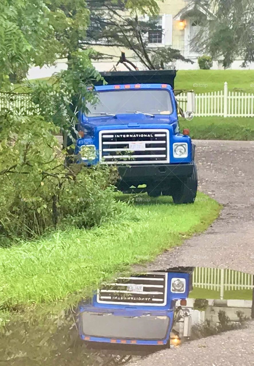 Truck with reflection in a water puddle 