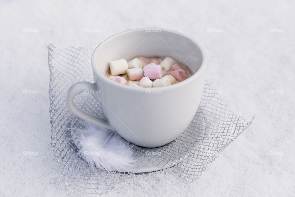 coffee with marshmallow on snow