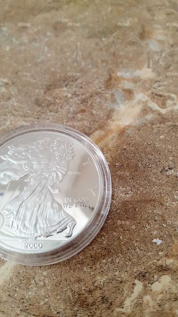 silver coin in GOD we trust