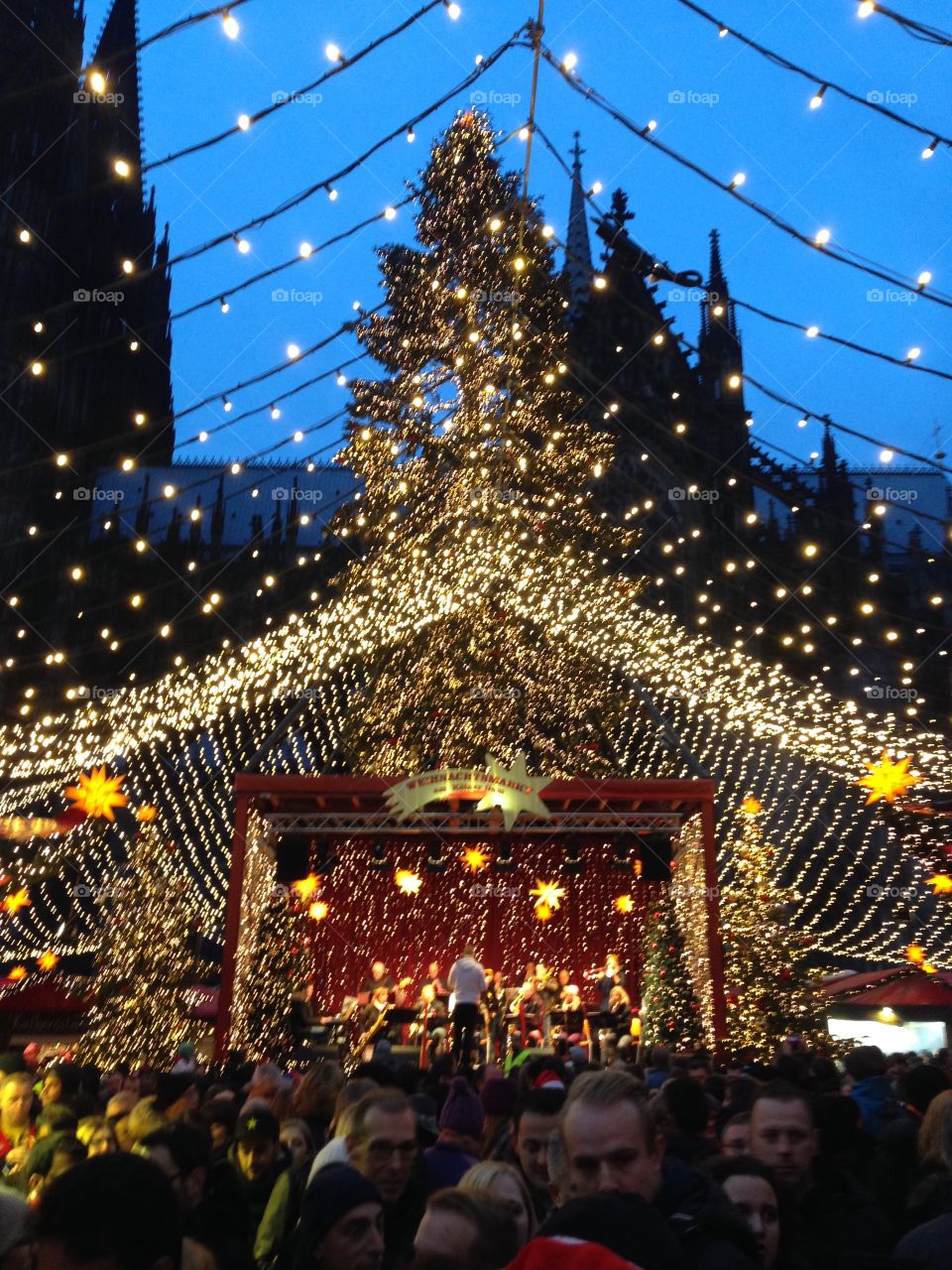The center of the Christmas Market in Cologne, Germany is a beautifully lit stage with the world's tallest cathedral in the background. 