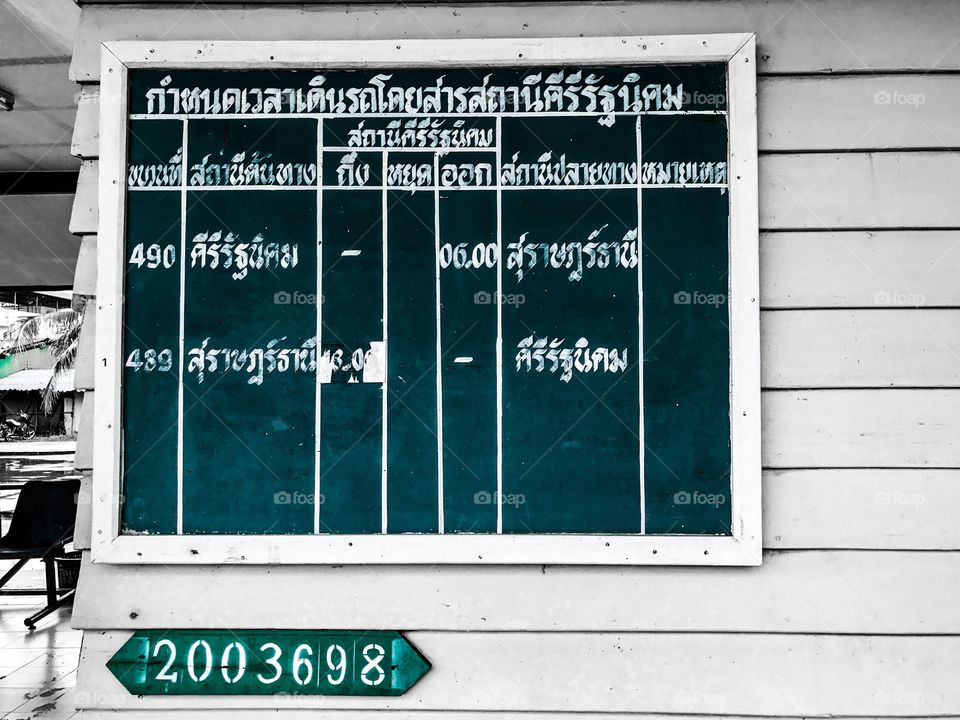 Daily train schedules board at Khiri Ratthanikhom Railway Station in Surat Thani, southern province of Thailand