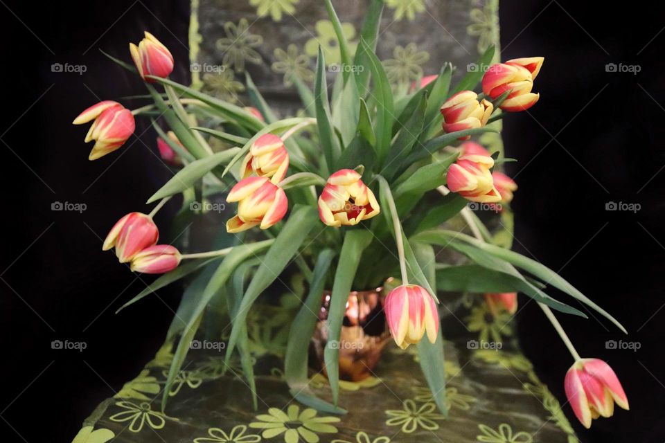 Red yellow tulips in the metallic vase