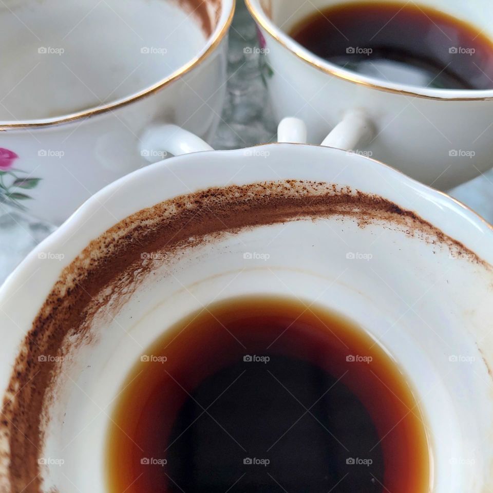 coffee in a partially drunk cup with traces of coffee on the edge of the cup