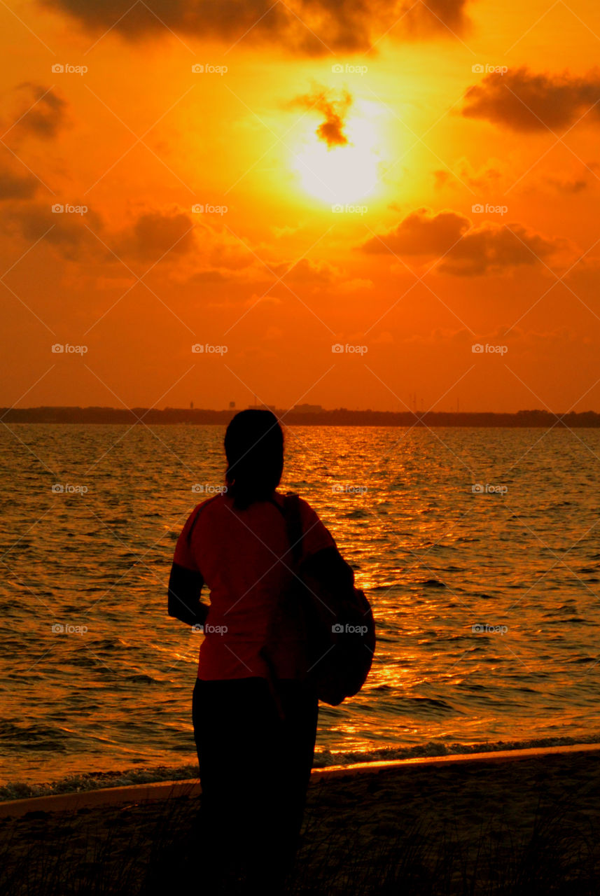 The sky was filled with the most brilliant orange complimented perfectly with hues of gold, yellow, red and crimson. An orange haze had casted over the water, reflecting off every wave. Finally,the sun disappears along with the shine. I can only wait to see another magical moment of beauty and warmth! I can only wait for another sunset! Enjoy!