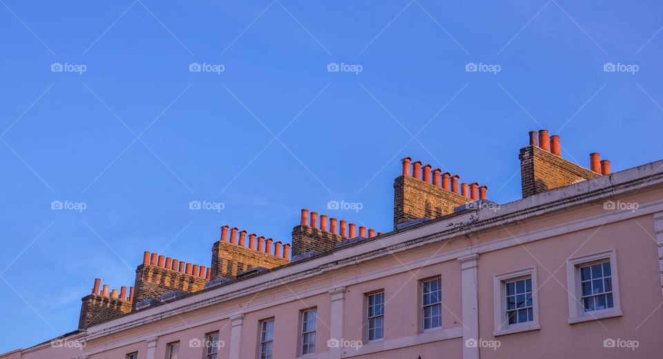 Chimneys on pink building 