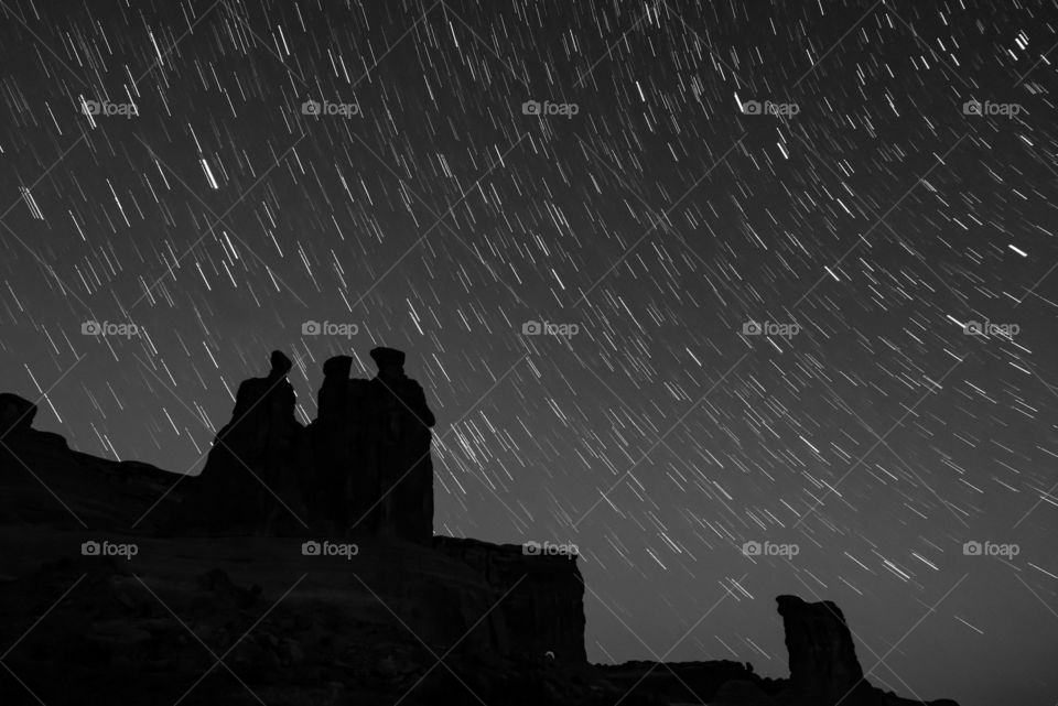 Silhouette Stars: The Three Gossips stand tall, gossiping well into the evening. 