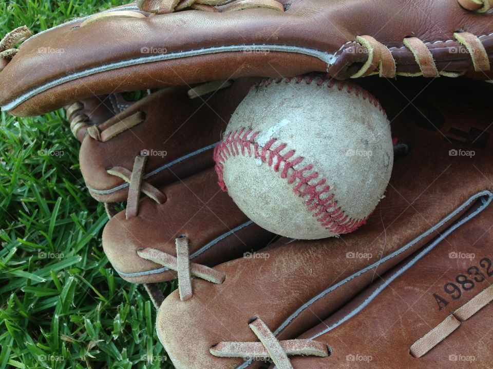 Baseball And Glove On Grass