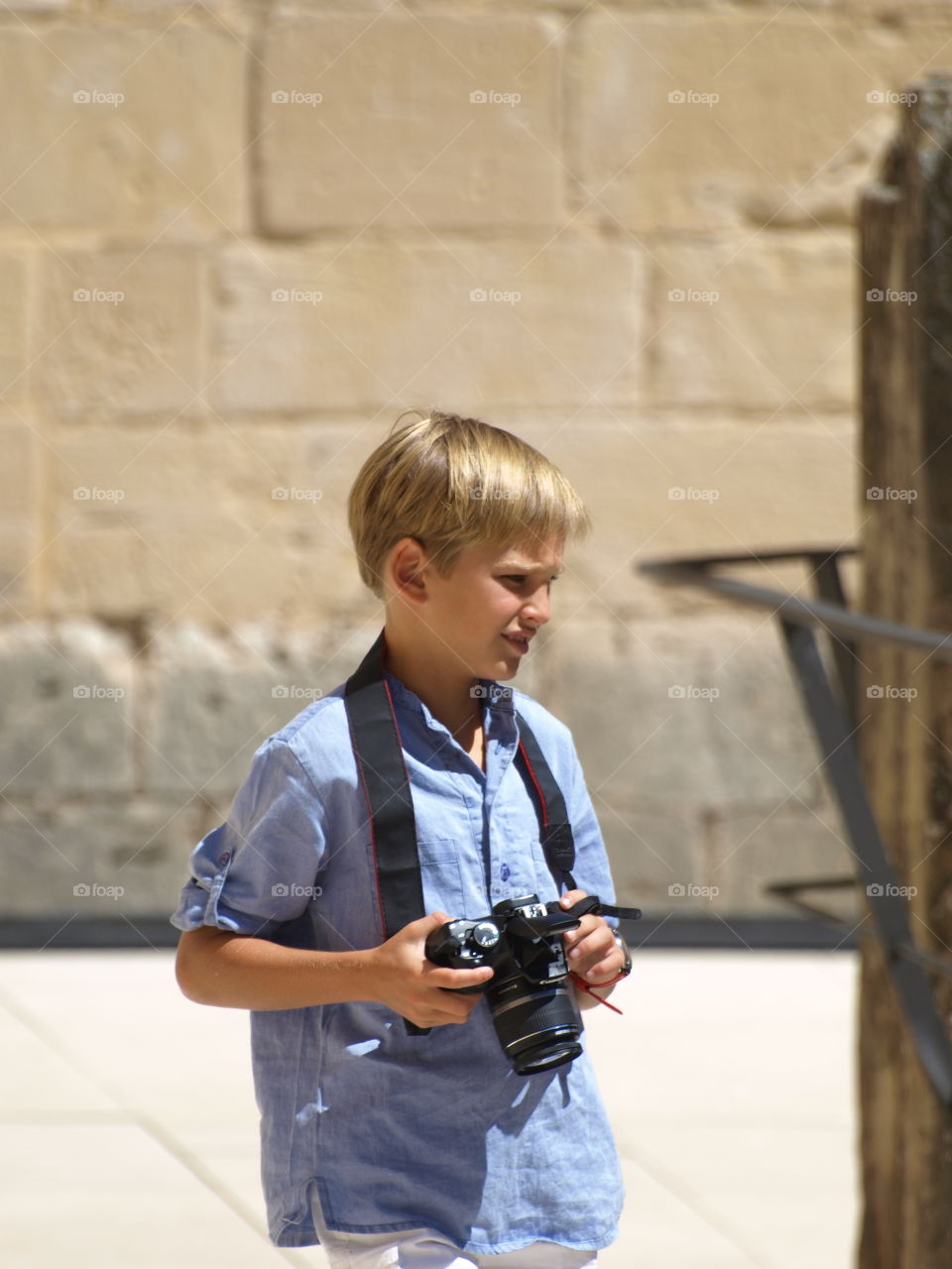 Close-up of a boy with camera