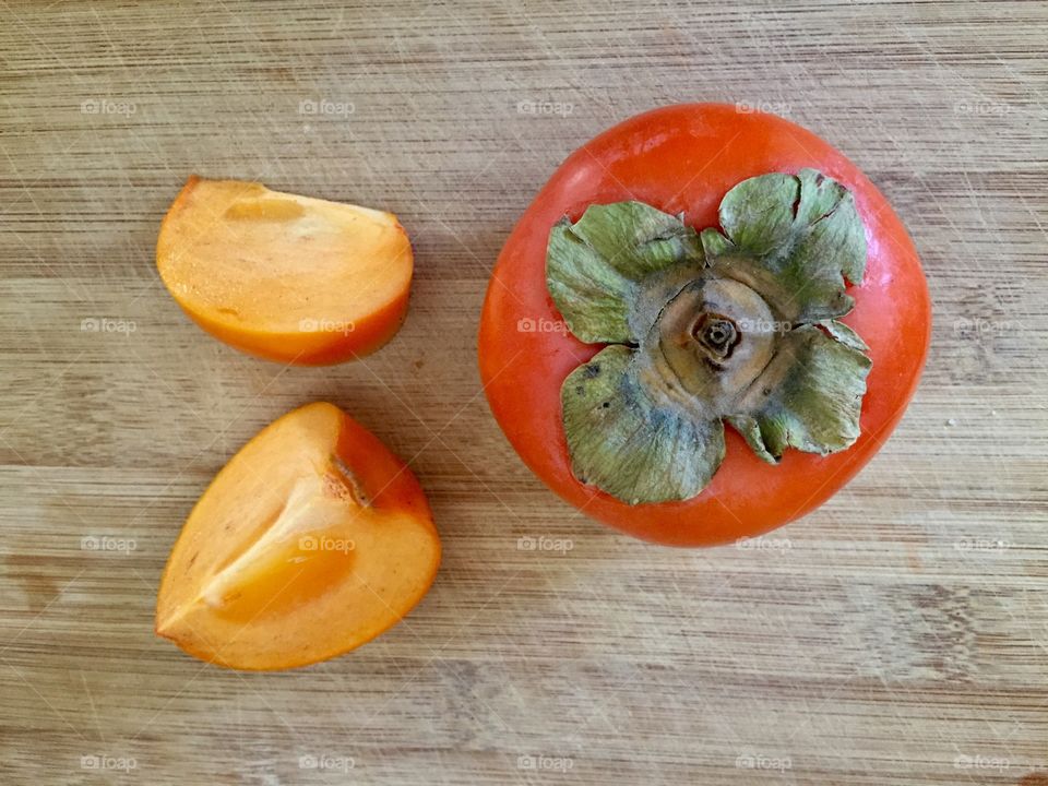 Persimmon on bamboo board 