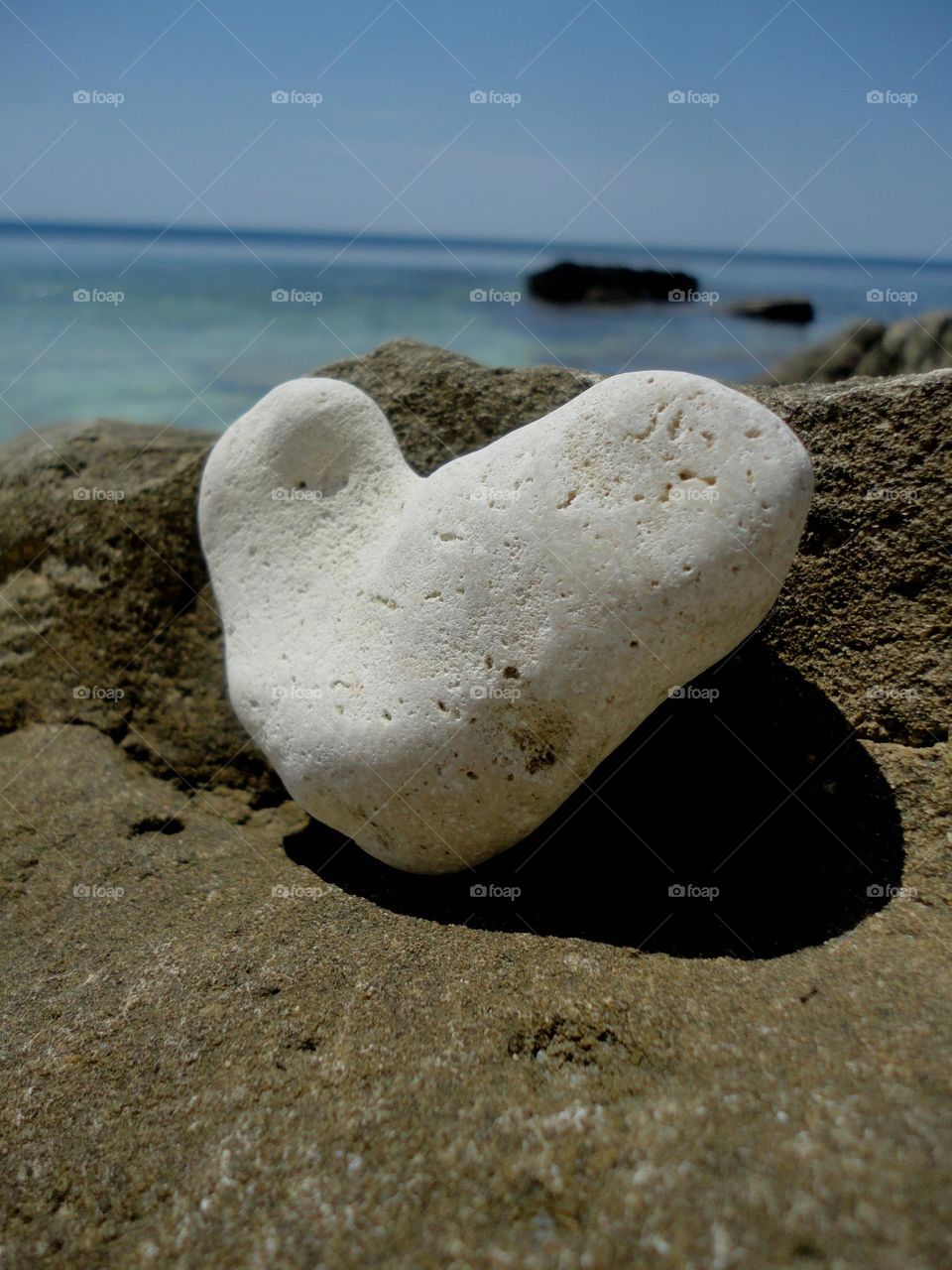 white stone heart on a sea beach summer vacation
