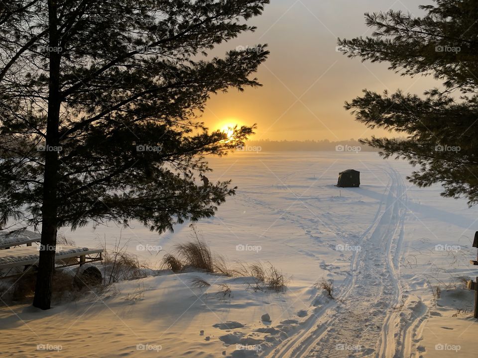 Ice fishing at sunset in Northern Wisconsin