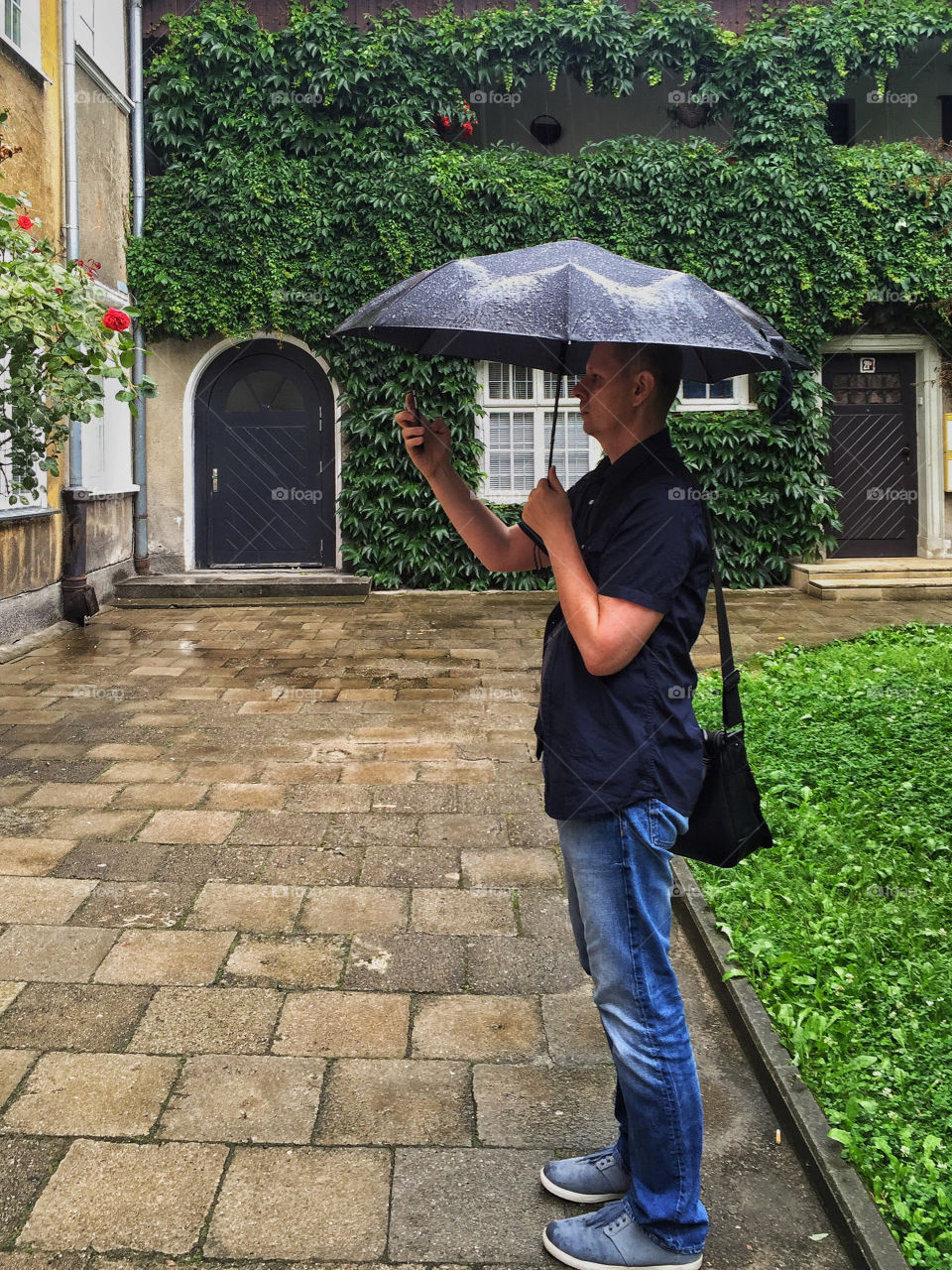 Man in casual holding umbrella