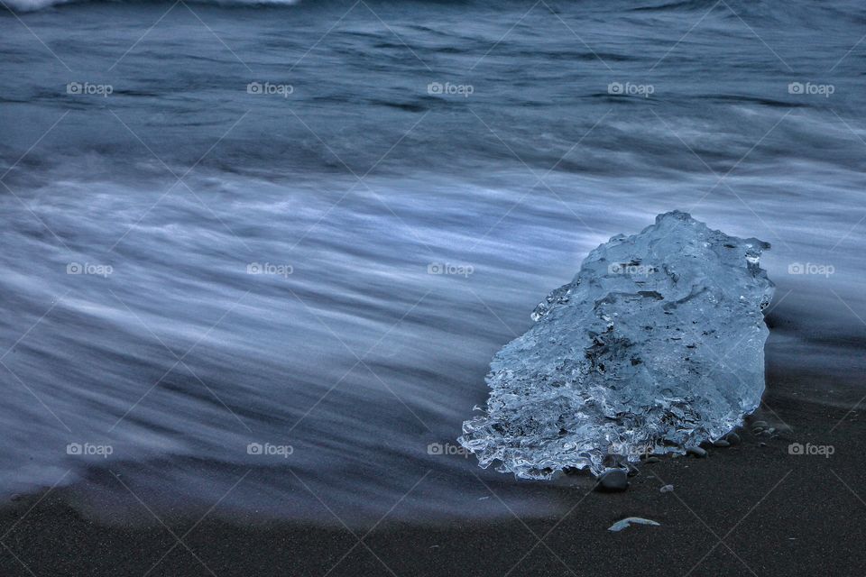 Ice on black sand at beach