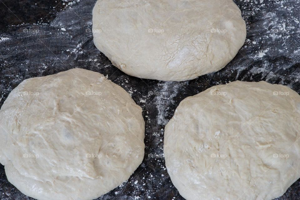 unbaked bread dough and flour