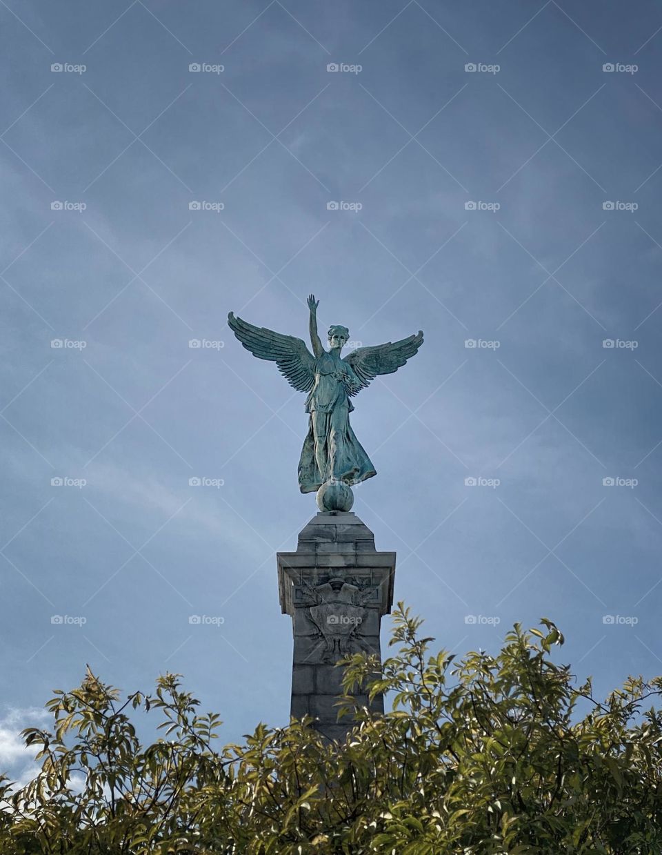 The winged Goddess of Liberty statue on top of the George-Étienne Cartier Monument at the entrance to Mount Royal Park in Montréal, Quebec, Canada