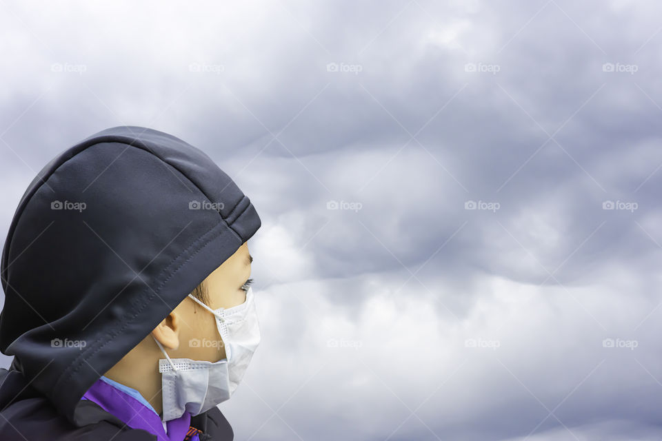 Asean Boys wear a mask to prevent dust in Bangkok ,Thailand.