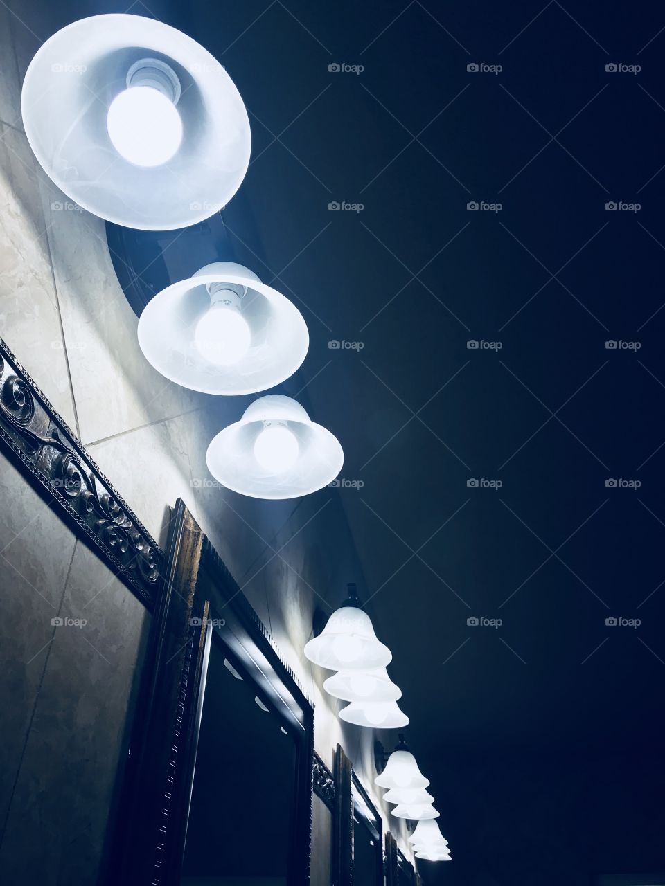 The bathroom sinks and the lights of the church building.  