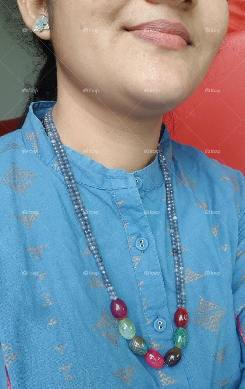 women with beads chain on her neck