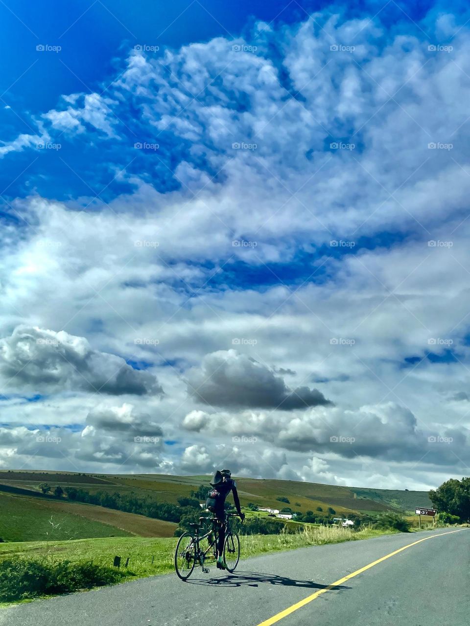 Man riding a twin bike with Spring as his audience. 