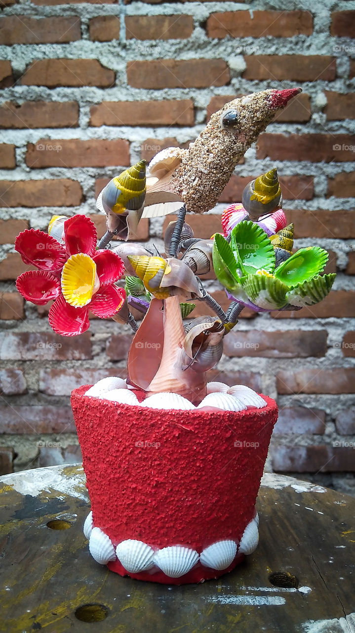 This is a picture of a craft made and assembled from raw materials for sea shells, which are arranged using glue