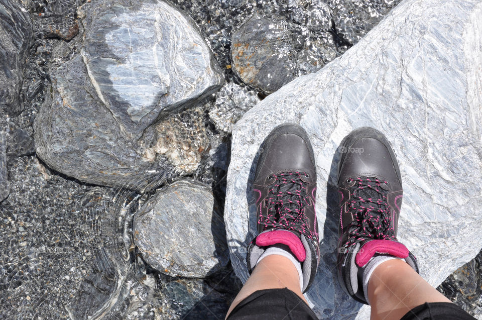 Hiking boots in a mountain stream