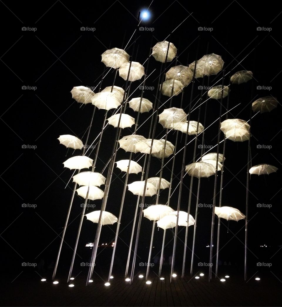 Night umbrellas. Sensational structure with umbrellas at Thessaloniki's seaside & under the moonlight 