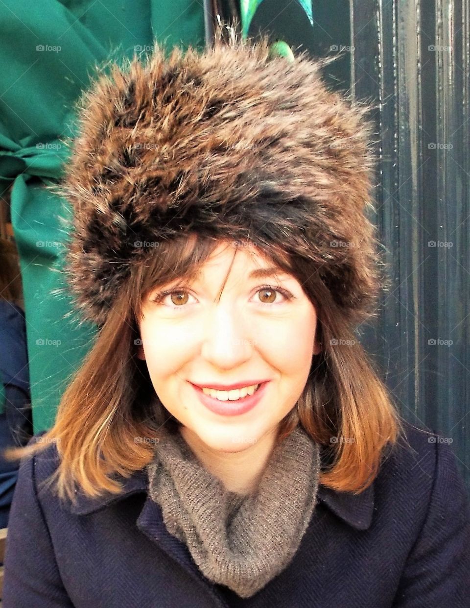 A young Woman wearing a fur hat