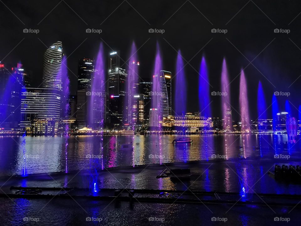 Singapore. Beautiful fountains show. Night city, night atmosphere, night photography. Dark sky. Skyscrapers. Architecture.