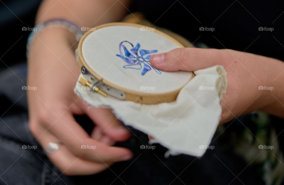 Woman doing embroidery work in indoors