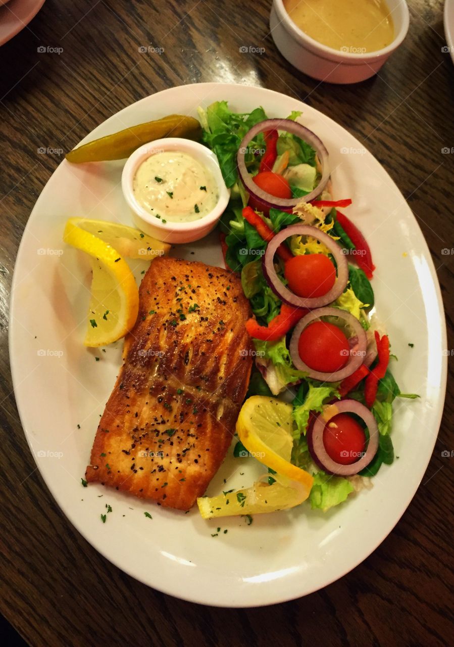 Healthy meal- salmon steak with salad and tatar sauce 