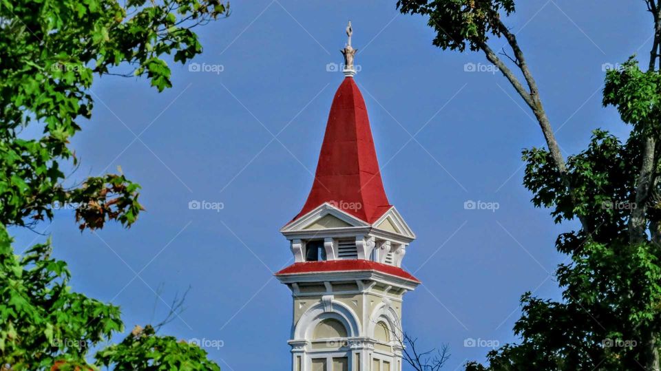 Blue sky contrast with Red Steeple