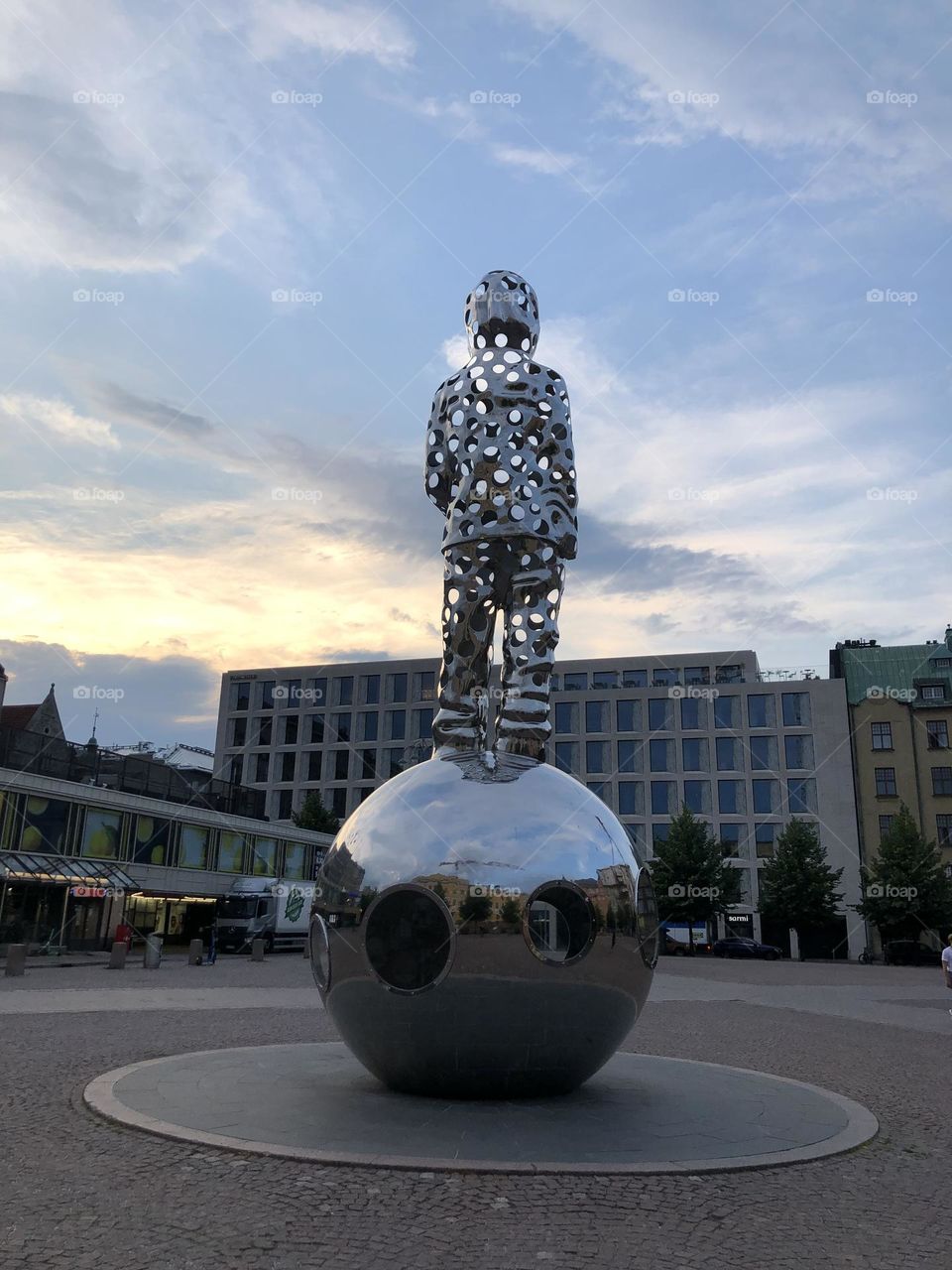 Man on sphere- sculpture 