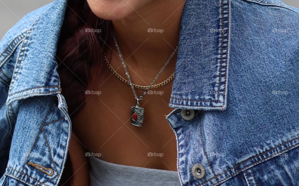 Stylish simple jewellery on a woman dressed in denim