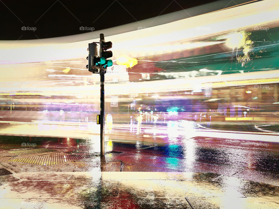 Traffic light and car light trails in the street of Galway city