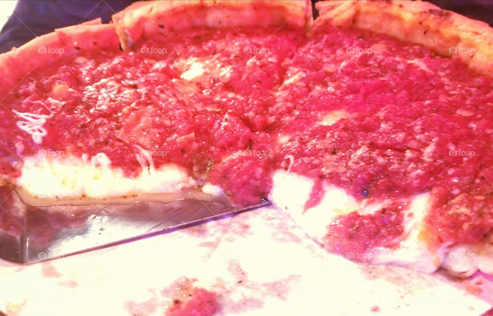 Cheesy Deep Dish authentic Chicago style pizza with tomato sauce on top.