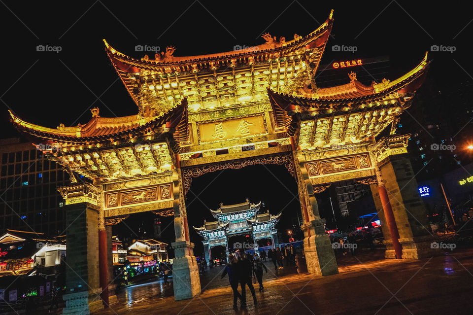 The gorgeous Golden Horse and Jade Rooster Gates at night in Kunming, China