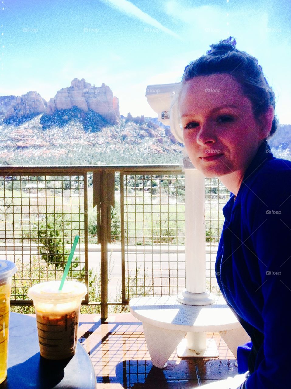 Blonde woman enjoying coffee in the mountains 