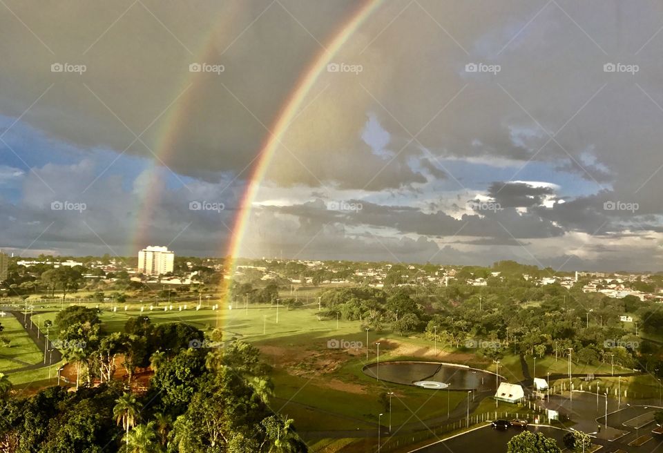 Scenic view of rainbow over town park