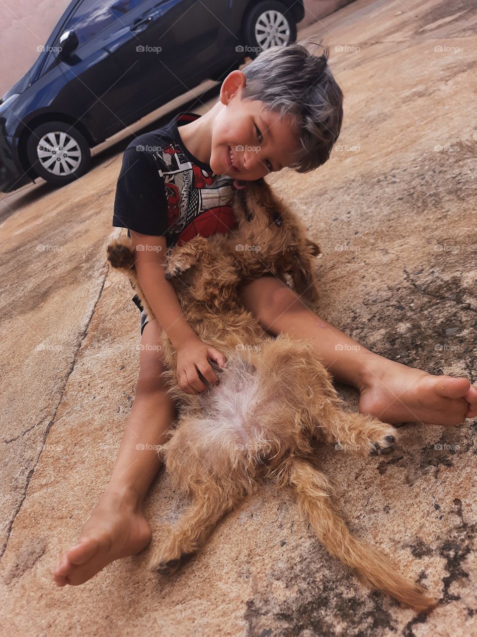 smiling child playing with the dog