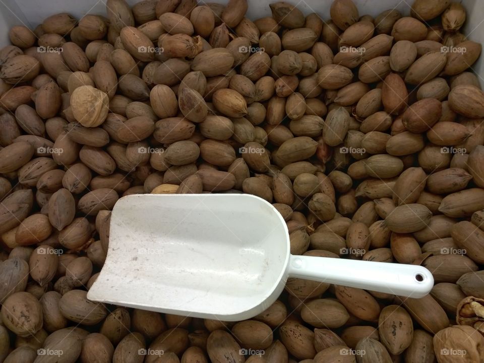Walnuts with a scooper.