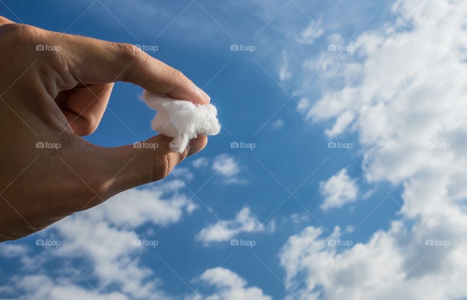 A piece of cloud from the sky in hand between fingers. 