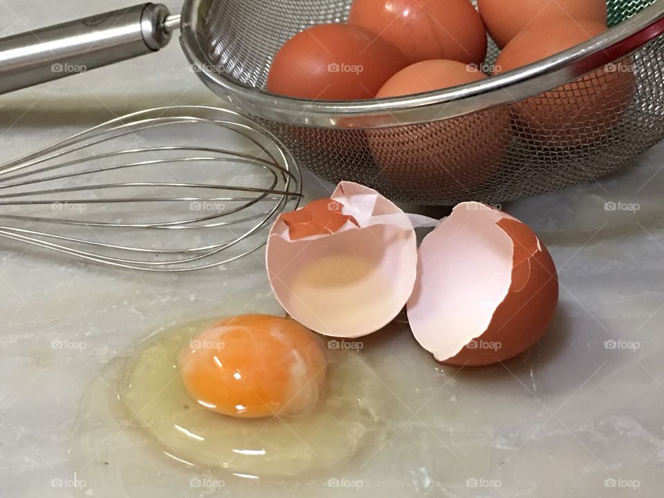 Farm fresh organic cracked brown egg closeup 