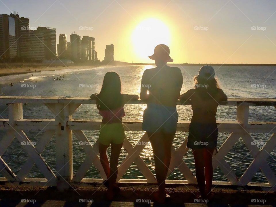 Three girls enjoying the sunset