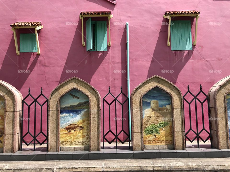 Pink house with green windows and Arabian paintings