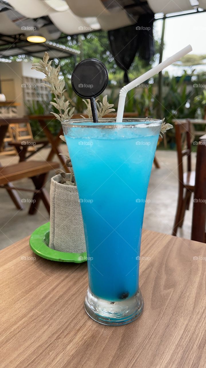 Cold blue soda in glasswater