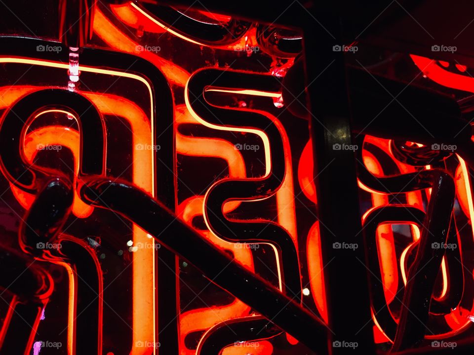 Behind the red neon lights in the window 