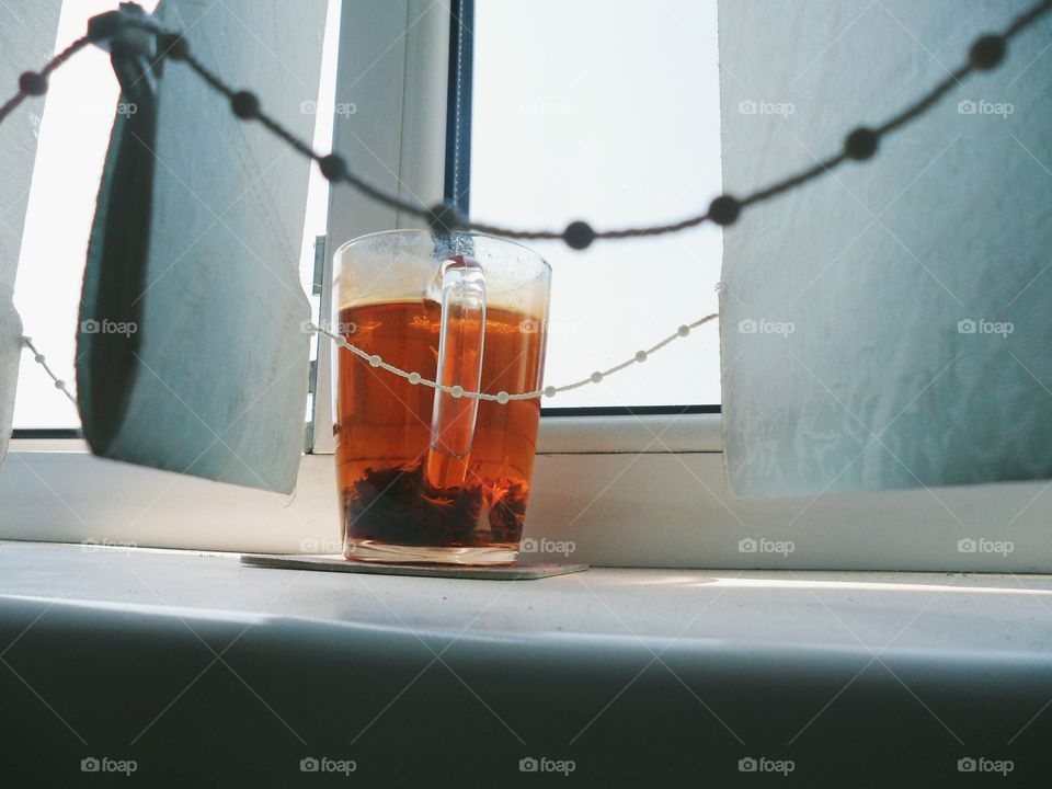 Cup of tea is on the windowsill